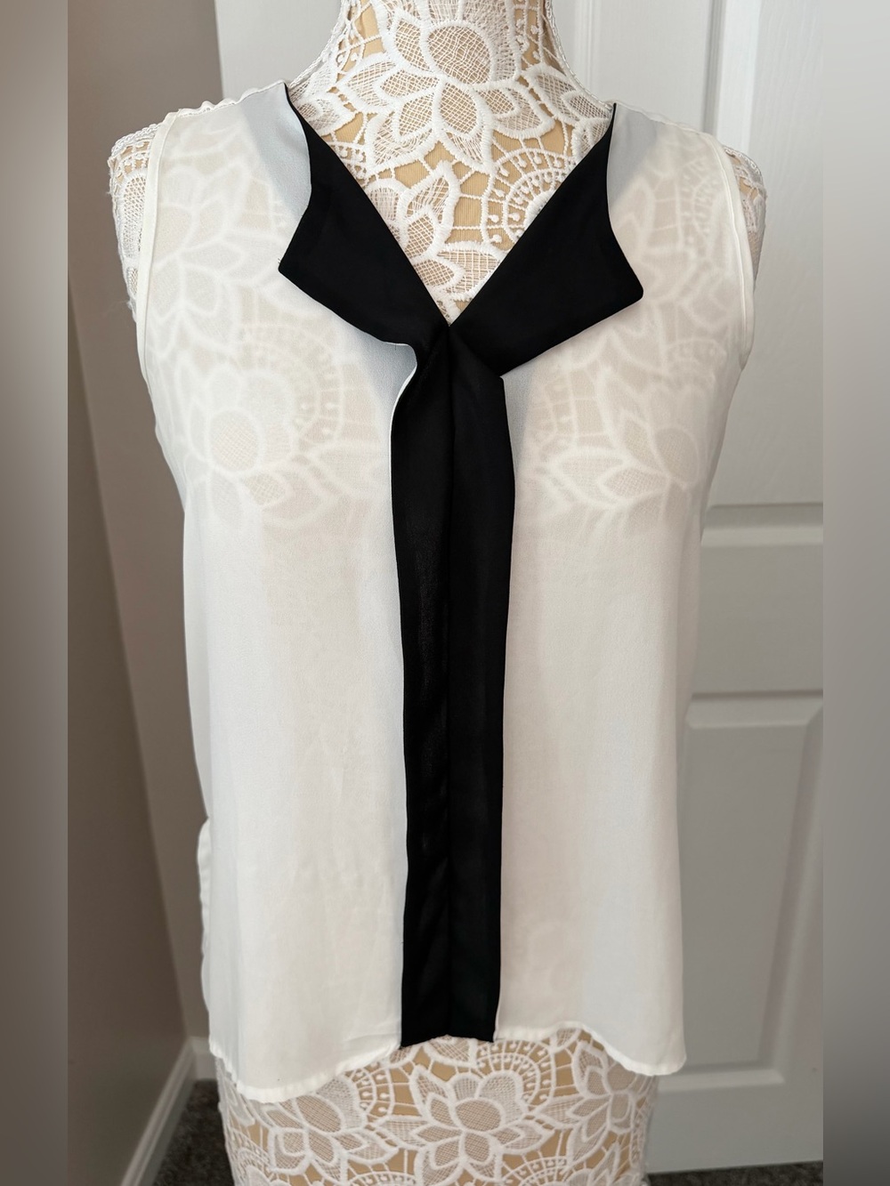 Sleeveless White Blouse with Black Tie Detail